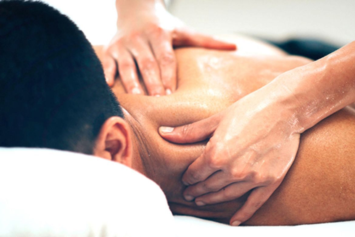 performing deep tissue massage on a male client in spa center bahria town Islamabad